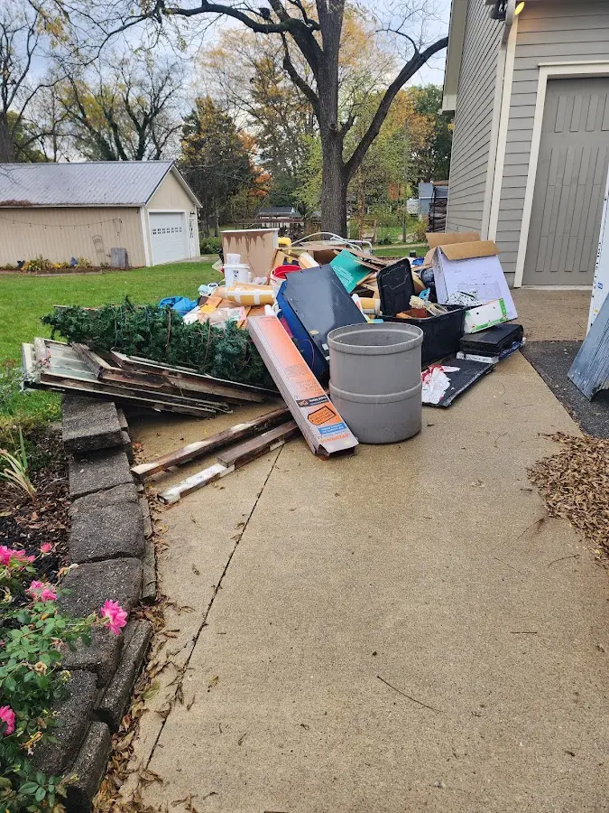Dumpster being loaded with debris for Estate Cleanout Dumpster Rental in St. Martinville